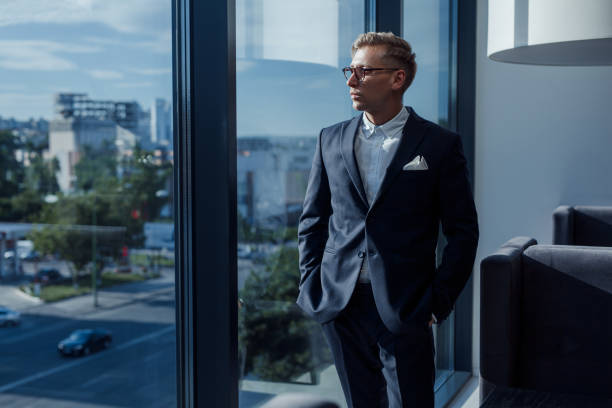 istock Stylish businessman posing near window 844233502