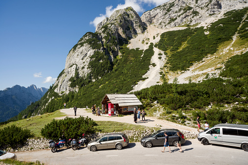 Kranjska Gora, Slovenia – August 17, 2017: Travelers at viewpoint on Vrsic Pass. The Vrsic Pass is the highest mountain pass in Slovenia. The mountain pass in the Julian Alps connects Kranjska Gora and the village of Trenta in the valley of the river Soca.