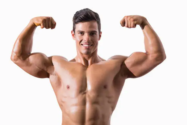 Portrait of a muscular young man flexing muscles over white background