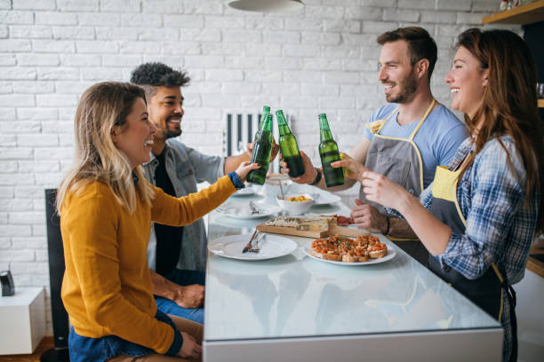 istock Couples saying cheers in a friend's kitchen 844246580
