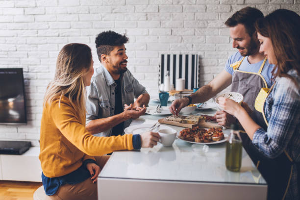 istock Mixed race couples laughing and preparing dinner together 844249520