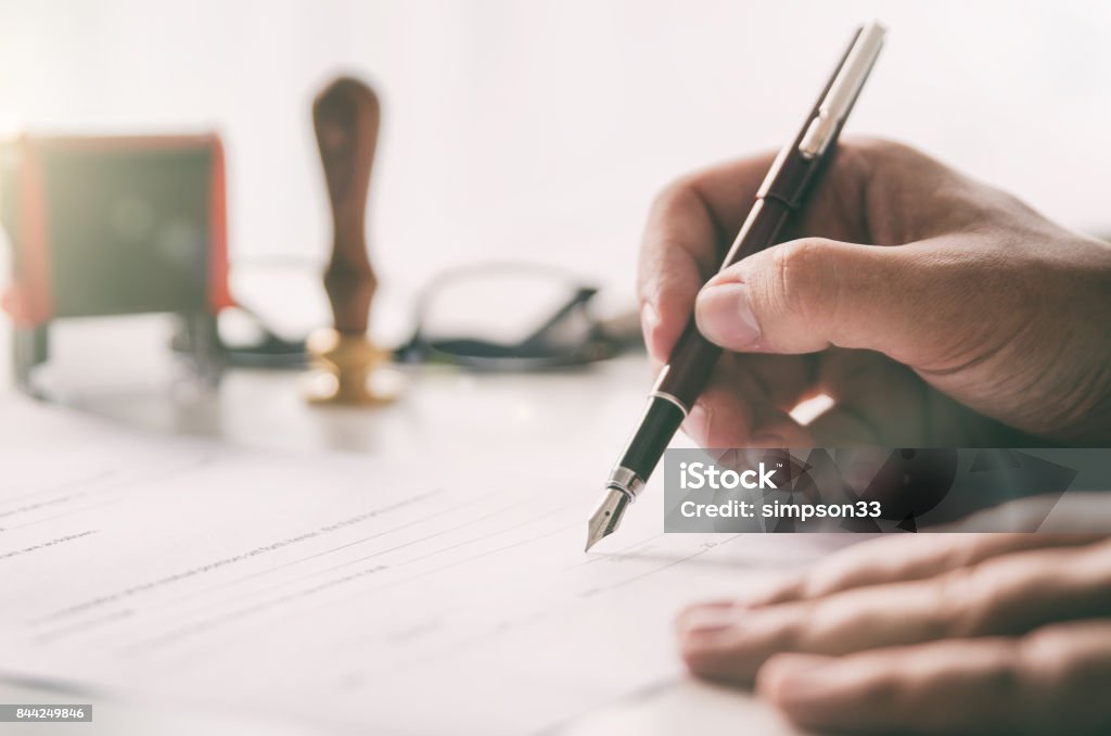 Notary signs legal contract. Businessman working in office Notary signs legal contract. Businessman working in office. notary public lawyer desk attorney office law official concept Fountain Pen Stock Photo