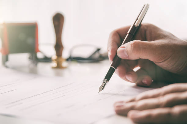 Notary signs legal contract. Businessman working in office Notary signs legal contract. Businessman working in office. notary public lawyer desk attorney office law official concept fountain pen photos stock pictures, royalty-free photos & images