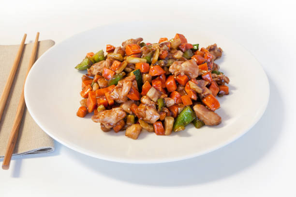 istock Kung Pao Chicken Presented on a White Plate with Chopsticks 844252792