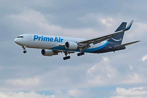 Ontario, California,USA- September 1,2017. Amazon Prime Air cargo jet landing at Ontario International Airport during summer storm. On thsi summer day, the weather made for difficult landings due to high winds and heat causing jets to abort their intial landing and retry landing again.