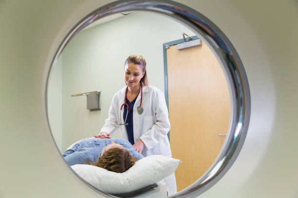 istock Female doctor preparing patient for CT scan 844272304