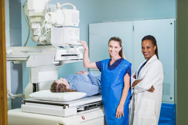 istock Female doctor and nurse with patient getting x-ray 844274504