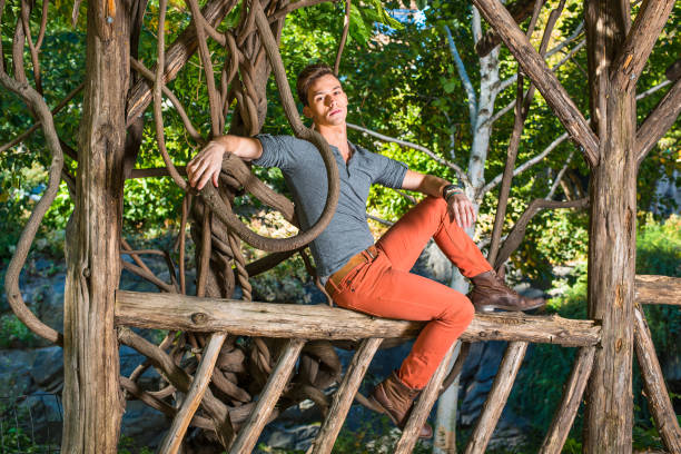 Young Man Relaxing Outside by trees