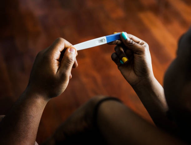 istock Black couple looking at pregnancy test 844275590