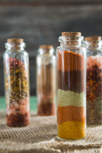istock Various spices in bottles on wooden table 844284432