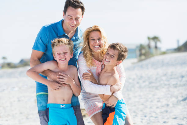 istock Happy family with two boys on beach 844297072