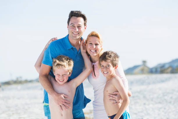 istock Happy family with two boys on beach 844297086