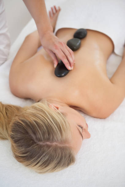 istock Beautiful blonde enjoying a hot stone massage 844300184