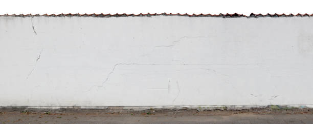 istock Long white cracked plastered wall and fence  isolated fragment. 844311686