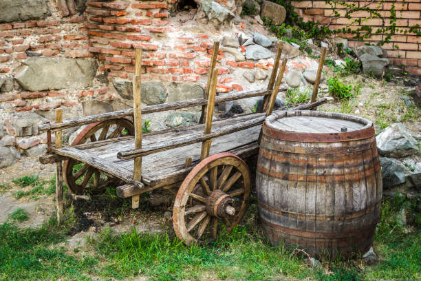 The abandoned cart and an old wooden barrel in the backyard.