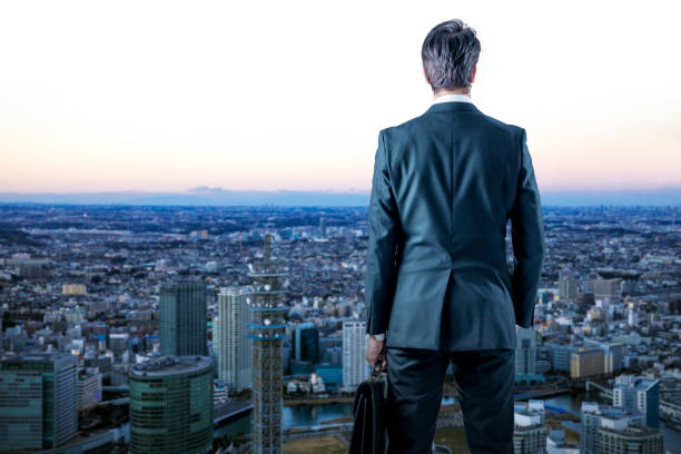 istock businessman looking down a modern city. business prospect concept. 844315210