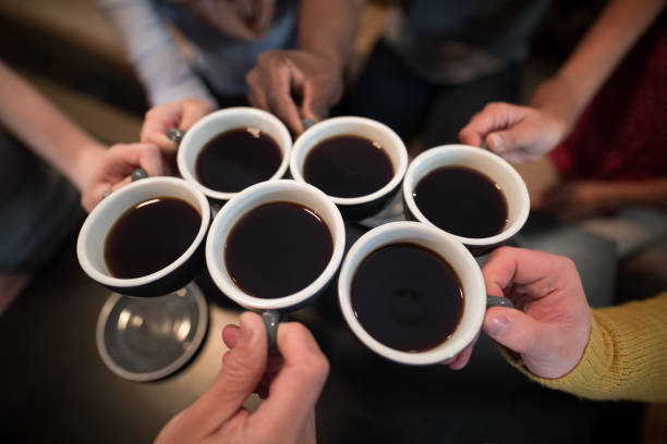 istock Mid section of friends toasting coffee 844316618