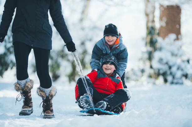 istock Mom and sons playing in snow 844319622