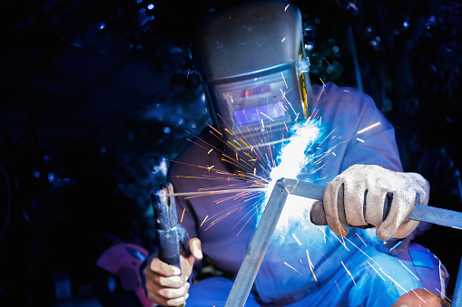 Welder welding structure material with lighting sparks