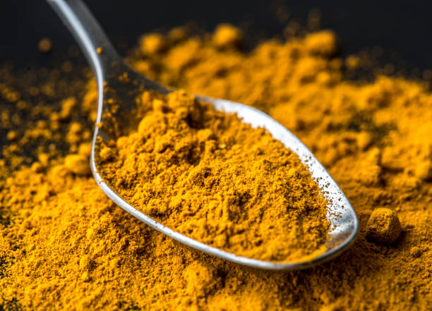 istock Closeup of tumeric powder spice on a spoon 844323332