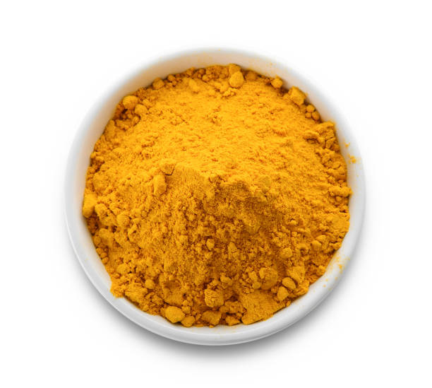 istock Turmeric powder in a bowl on white background 844323482