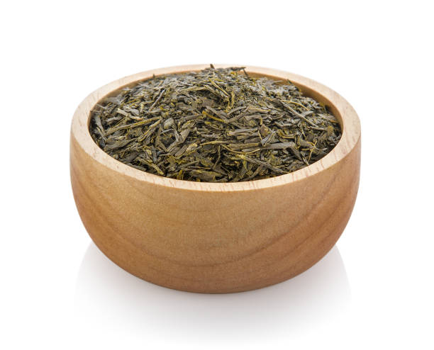 istock dried tea in wood bowl on white background 844324668