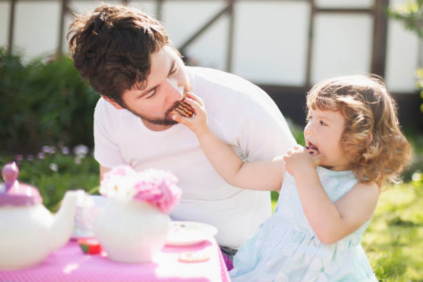 istock Cute little lady playing tea party with her caring father. 844327266