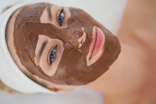 Beautiful blonde getting a chocolate facial treatment at the health spa