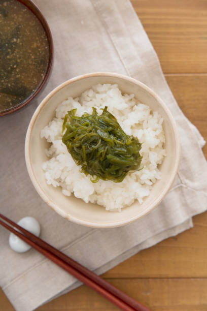 istock Warm steamed rice topped with Mekabu (a type of tender wakame seaweed) 844338048