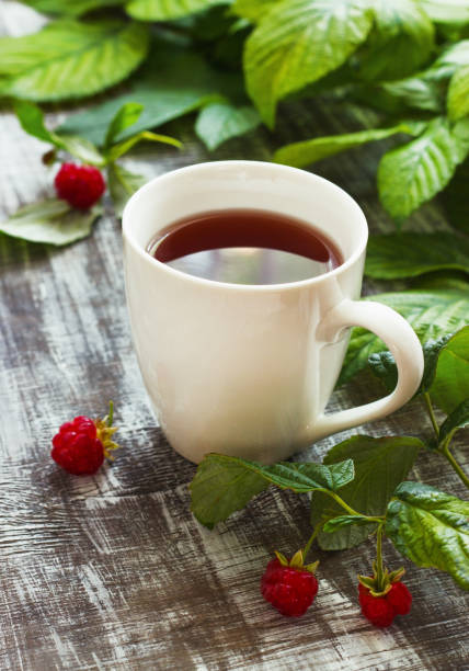 istock Tea with raspberries and raspberries on a wooden background. Place under the text 844346320