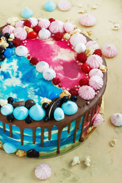 istock Bright celebratory cake double blue and pink with meringue and chocolate 844346450