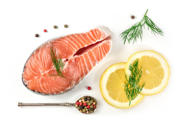 salmon steak with lemons, dill, and peppercorns, on white - pink pepper fotos imagens e fotografias de stock