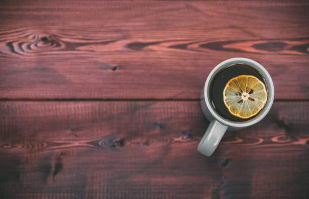 istock tea cup with slice of lemon on wooden background. Free copy space for text 844349918