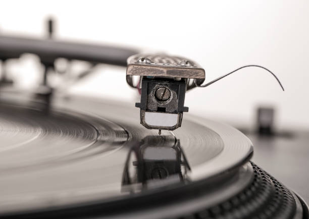 istock Old dusty vinyl turntable player isolated over white background. 844350278