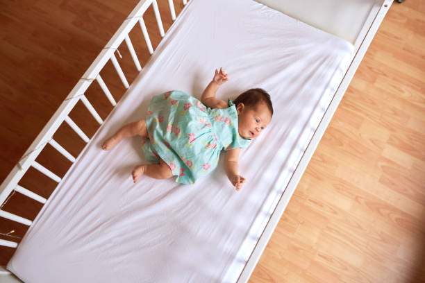 istock cute baby girl in her bed 844353020