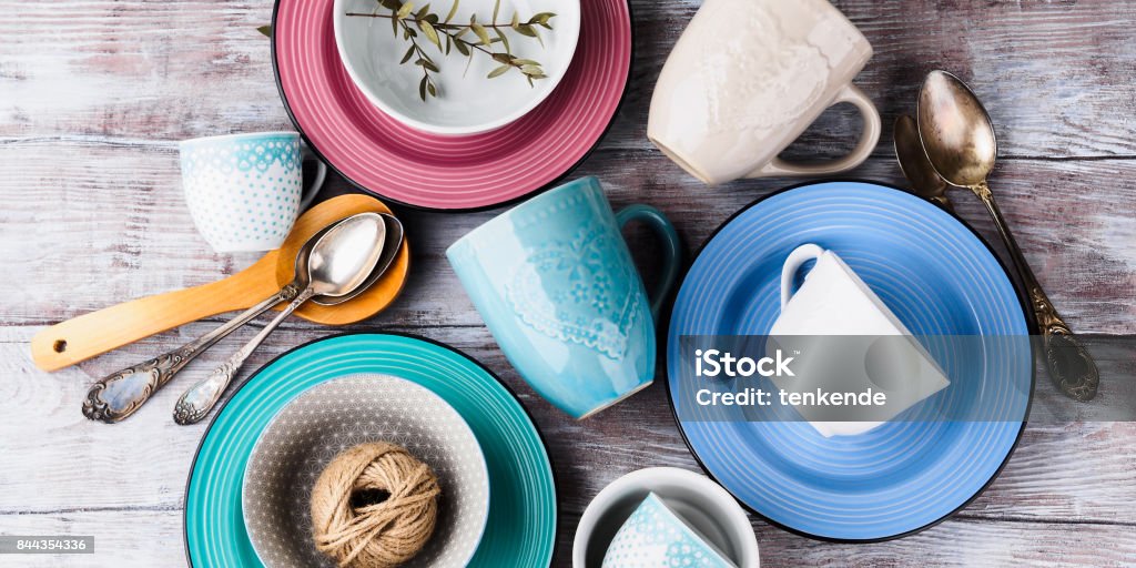 Ceramic crockery on wooden background Ceramic crockery tableware on wooden background. Pastel vintage color bowls, dishes, cups Plate Stock Photo