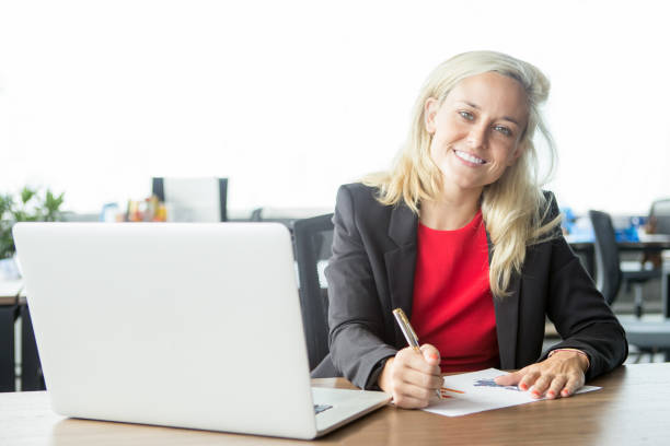 istock Cheerful confident businesswoman doing paperwork 844355972