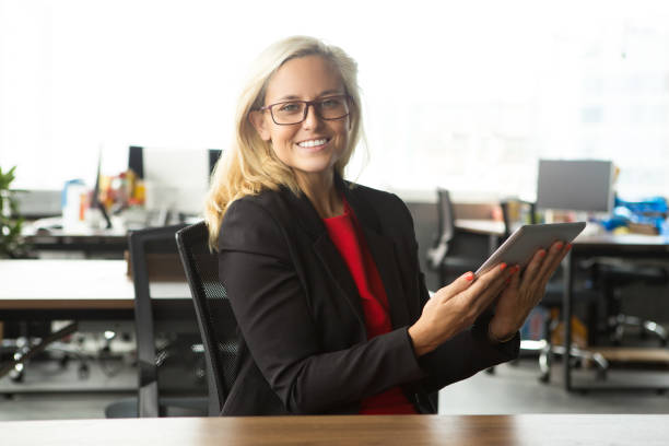 istock Cheerful businesswoman holding digital tablet 844356546