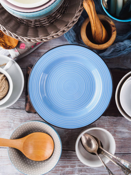 istock Ceramic and enamel crockery on wooden background 844356684