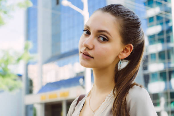 istock Young woman looking at camera. Student near university 844356698