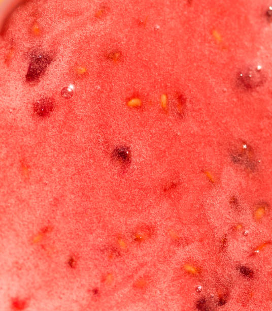 red honey with berries as background