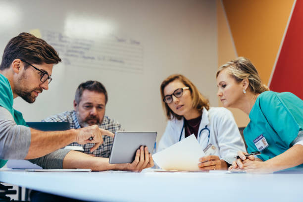 istock Healthcare workers having a meeting in boardroom 844360434