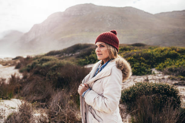 istock Woman standing on the beach in winter 844360704