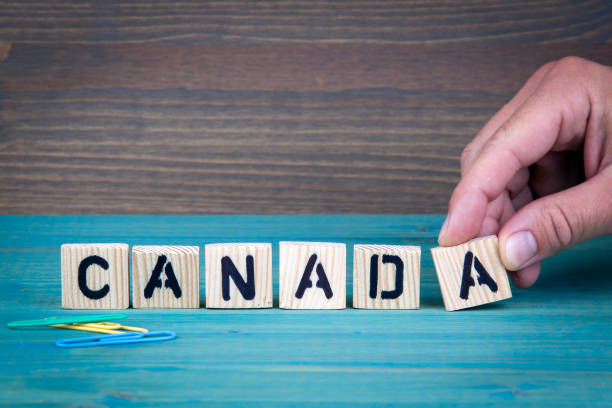 istock Canada. Wooden letters on the office desk, informative and communication background 844360766