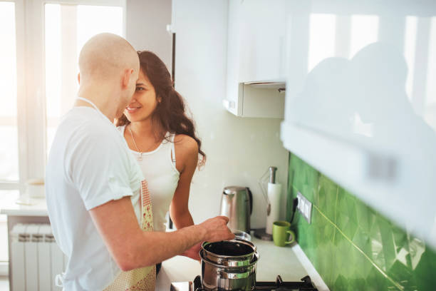 istock Happy young couple preparing on the stove 844361024