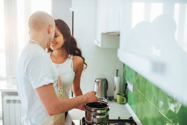 istock Happy young couple preparing on the stove 844361062