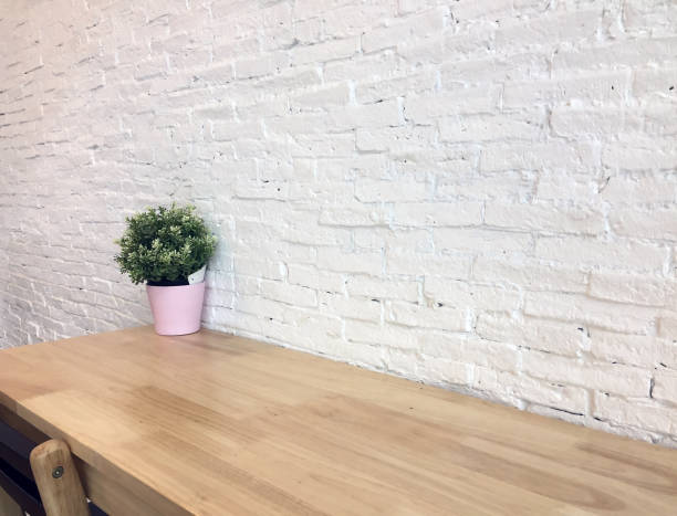 istock Green plastic tree in the pink pot set decor on the wooden table and white wall background. 844361068