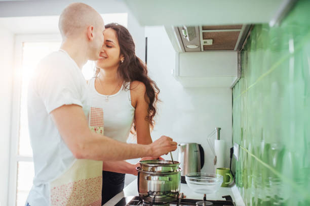 istock Happy young couple preparing on the stove 844361122