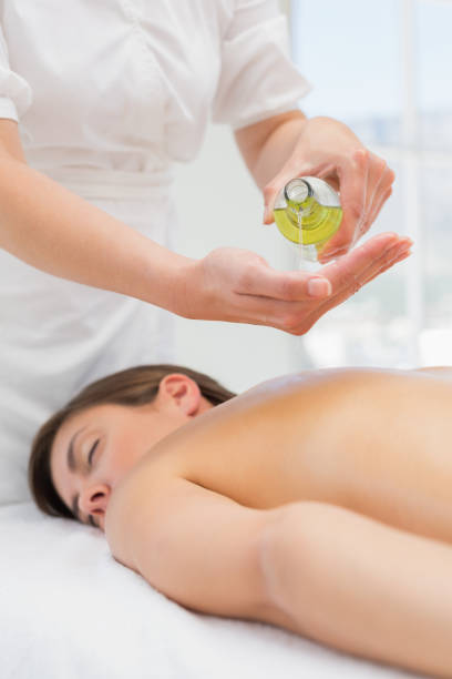 istock Woman getting massage oil on her back at spa center 844364352