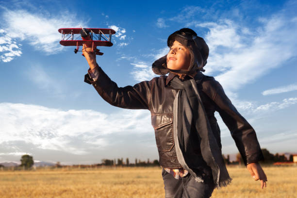 istock Boy playing with toy airplane 844364440
